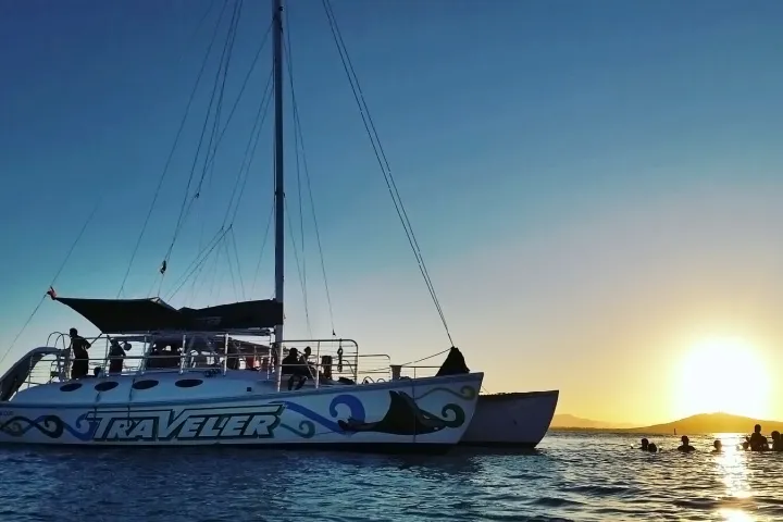 Traveler sunset tour with people swimming in the water