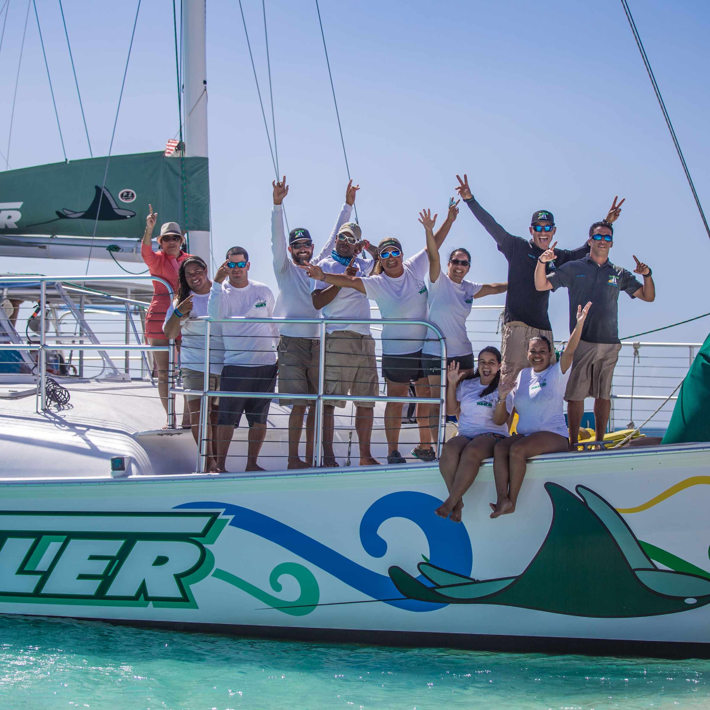 people waving their hands on a boat